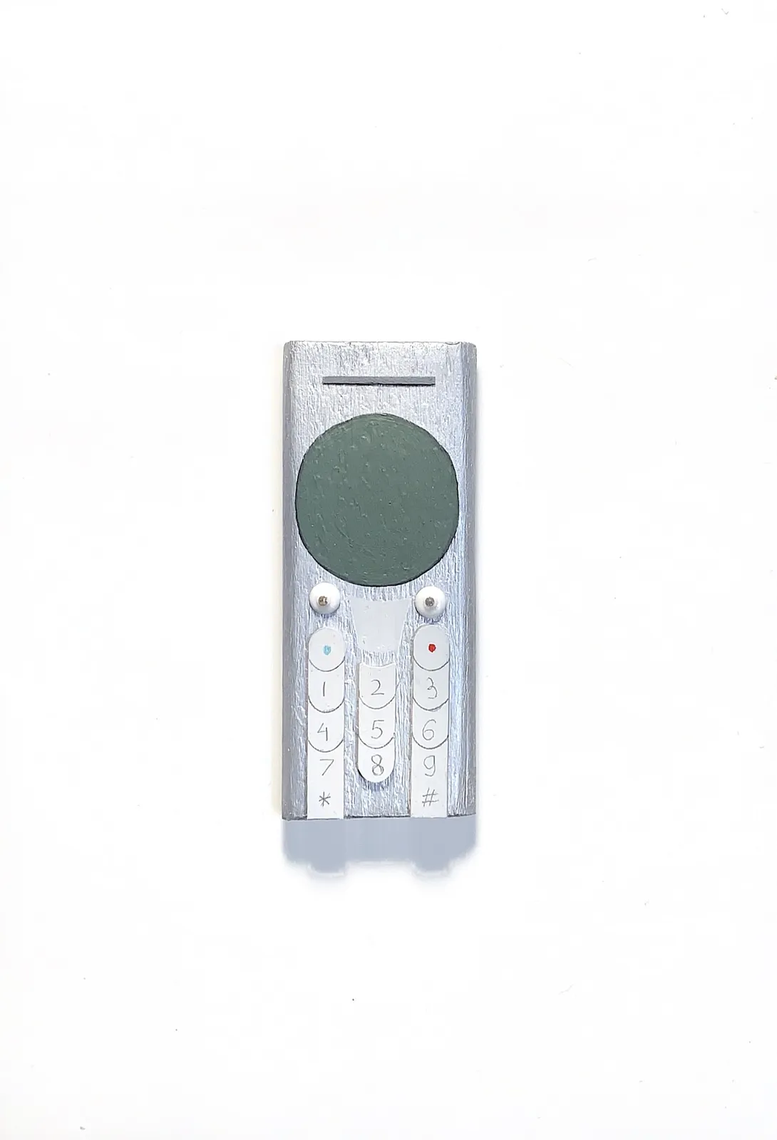 Image of Phones by Adriana Shportan, size: The average size of one phone 10 cm × 5 cm × 1.5 cm, made of wooden blocks, acrylic paint, and found/recycled materials;, Installation medium, from London, part of the “When It Is Our Turn to Be Adults” series Photo 6 of 17.